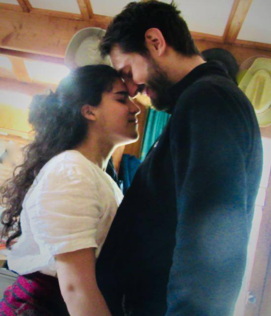 A couple standing with foreheads touching