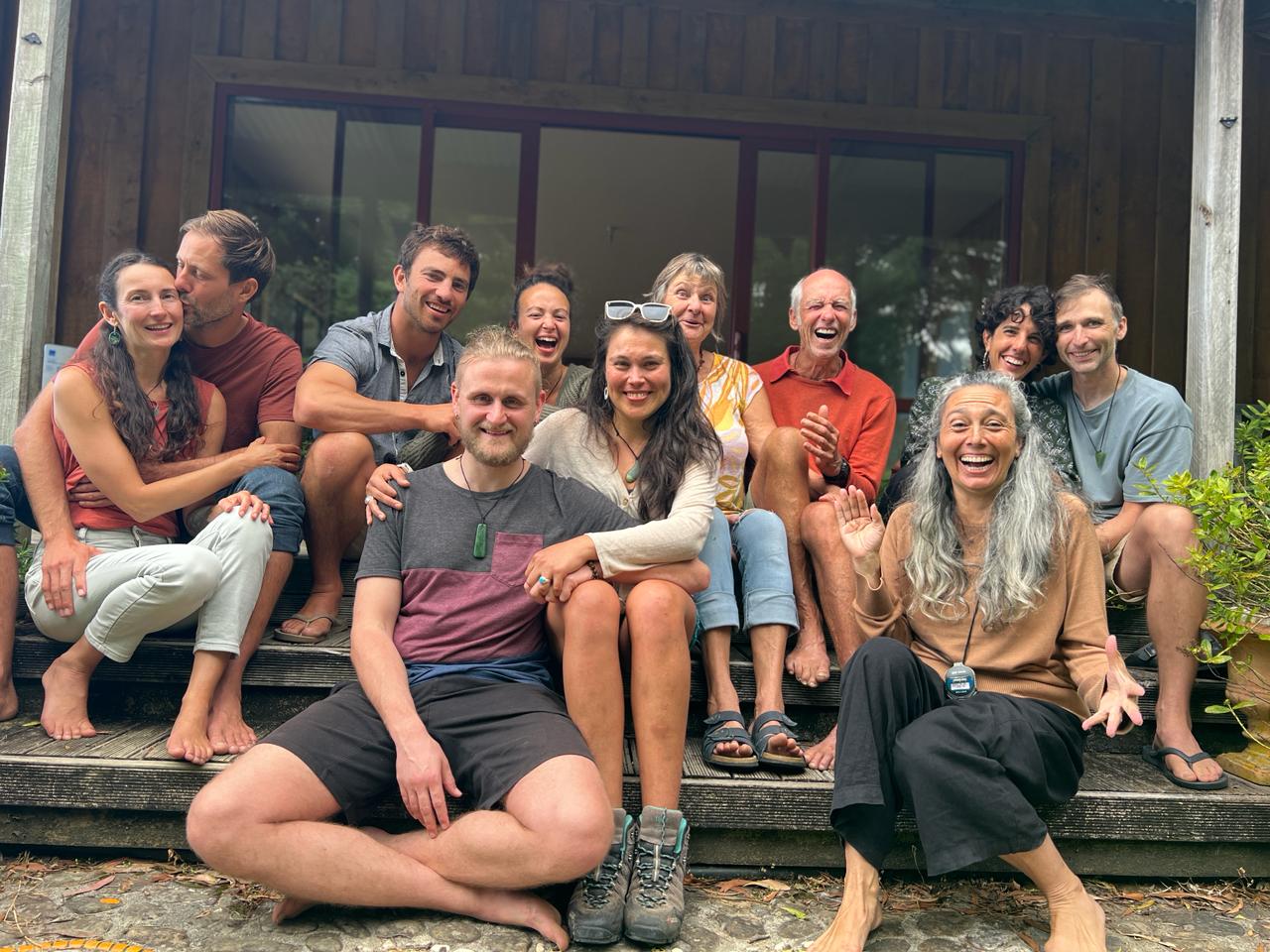 Participants laughing together on the steps after a session